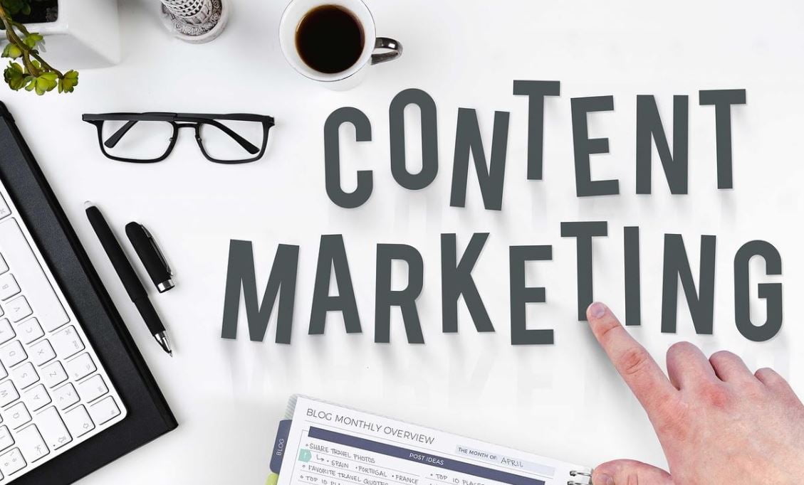  A hand pointing at the “Content Marketing” title
